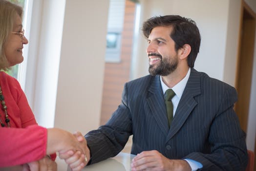 Professional sealing a deal with a client through a handshake